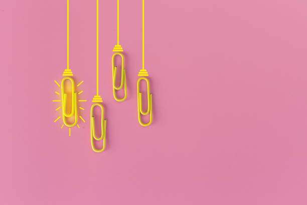 istock Great ideas concept with paperclip,thinking,creativity,light bulb on pink background,new ideas concept. 1212511540
