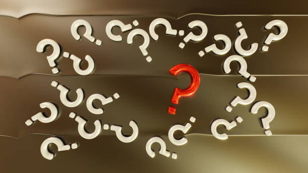 istock Focus on One Big Red Question Mark and some White Question Mark put on a Golden Metallic surface 1212511963