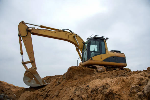 istock Excavator at earthworks on construction site 1212514649