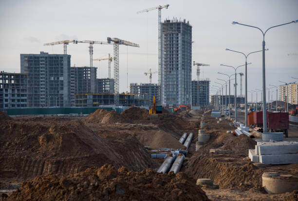 istock Drainage pipes at the large scale construction site against tower cranes 1212515547