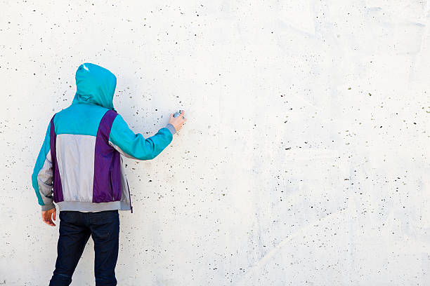 istock Graffiti artist in jacket with copy space to draw 121251566