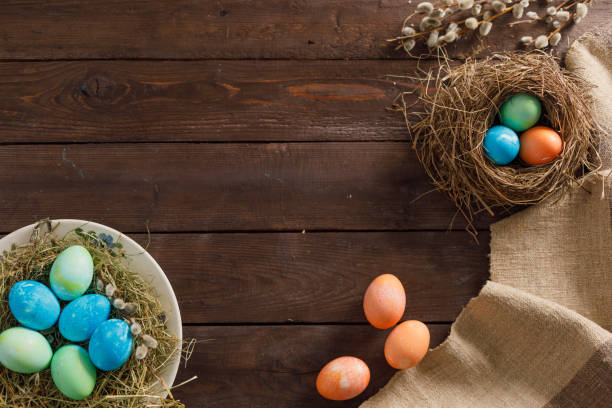 istock Still life many colorful easter eggs on a wooden background. Rustic. Decoration from natural fabrics and herbs. Easter celebration concept. Flat lay 1212516252