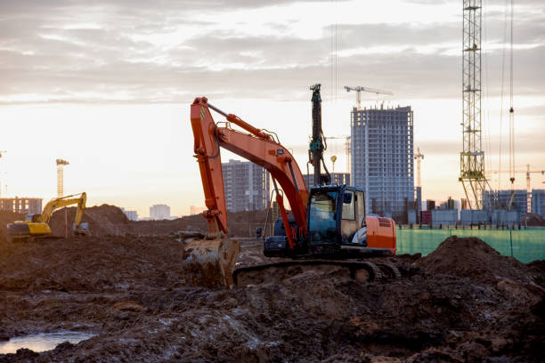 istock Excavators at construction site on the background sunset 1212516371
