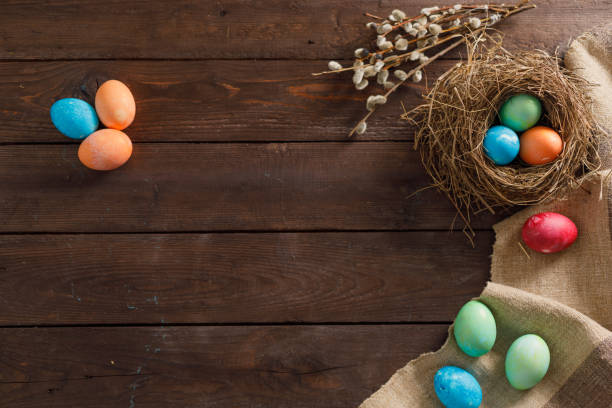 istock Still life many colorful easter eggs on a wooden background. Rustic. Decoration from natural fabrics and herbs. Easter celebration concept. Flat lay 1212516514