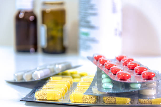 istock Medicine pills of different colors and dimensions on stack, cure for disease and viruses 1212518398