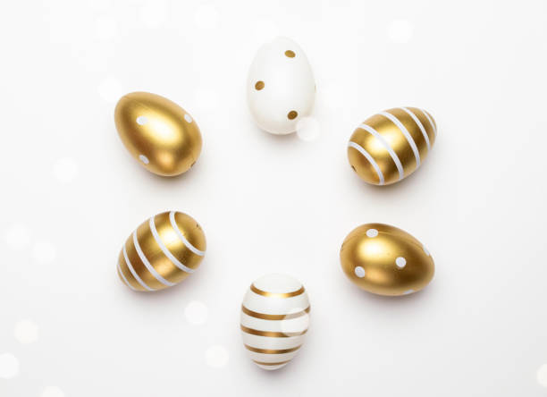istock Happy Easter eggs white background. Golden shine decorated eggs in basket, for greeting card, promotion, poster. 1212518570