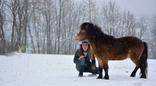 a menina com os cavalos na fazenda - horse inside of mountain snow - fotografias e filmes do acervo