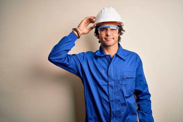 istock Young constructor man wearing uniform and security helmet over isolated white background confuse and wonder about question. Uncertain with doubt, thinking with hand on head. Pensive concept. 1212519938