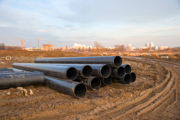 istock Cast iron sewer pipes for laying an external sewage system at a construction site 1212520167