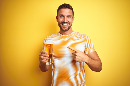 Three male friends are hanging out at home, drinking beer