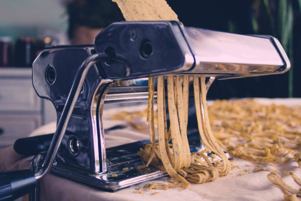 istock Fresh homemade Fettuccine, pasta  on the kitchen table, selective focus 1212521755