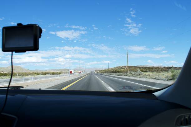istock View from passenger seat, looking out front window with outline of dashboard and GPS 1212527276