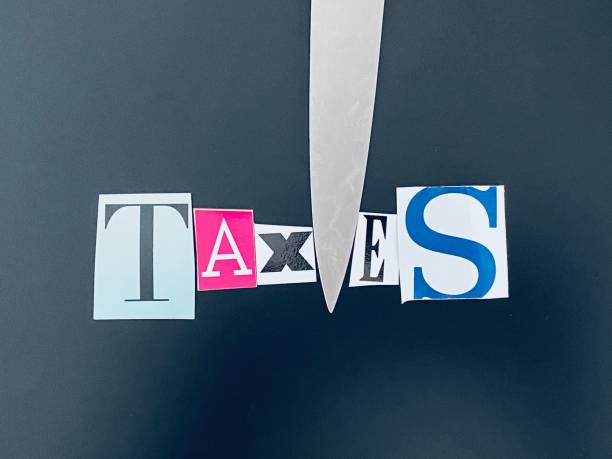 istock Knife cutting the word taxes 1212528176