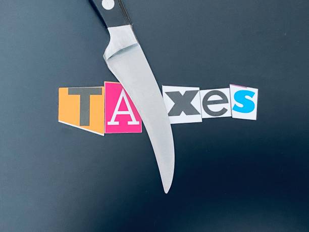 istock Knife cutting the word taxes 1212528228