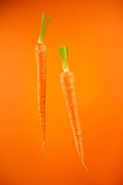 istock Carrots on an orange background 1212529764