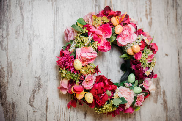 istock Holiday wreath hangs on the white wall 1212531892