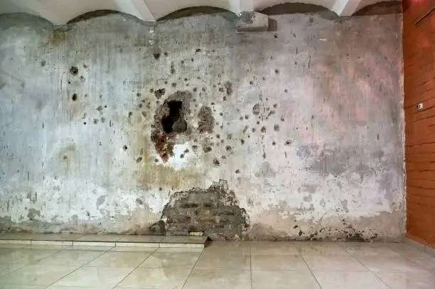 Photo of The wall in the basement near which people were shot