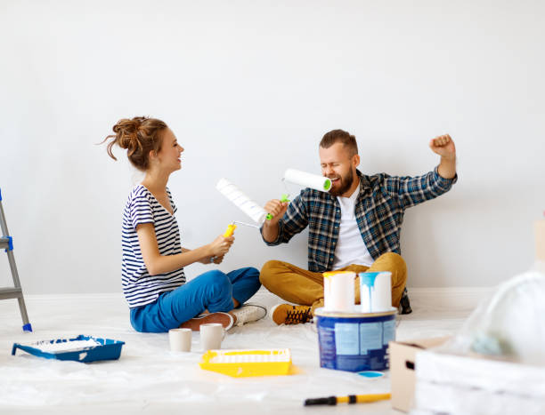 istock Young couple having fun during renovation 1212532951