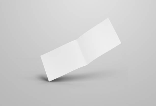 istock Empty open horizontal brochure template with realistic shadows. White bifold mockup isolated on gray background. 1212532956