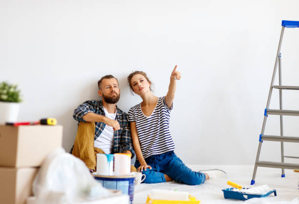 istock Young couple planning room interior 1212532989