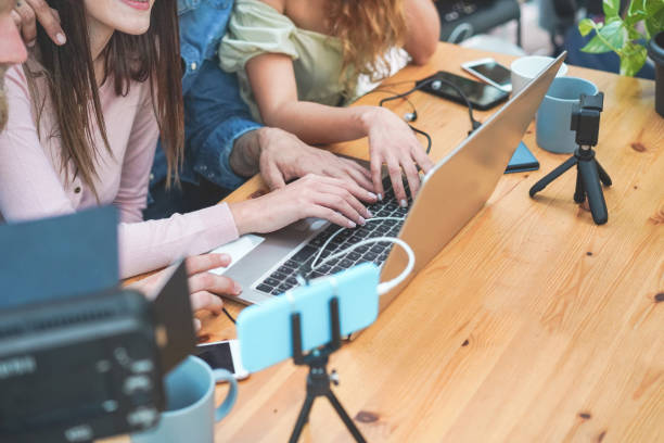 istock Young people streaming online using laptop, leds, smartphone and action cameras - Social network, vlogging and tech concept - Focus on left girl hand 1212533623