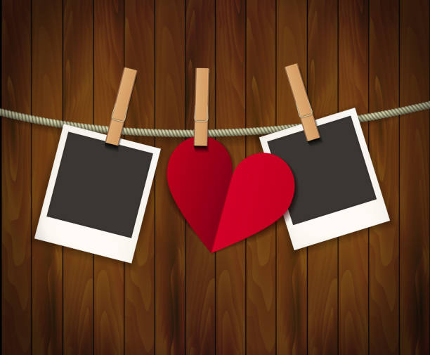 istock Two photo frames and heart for valentines day hanging on rope on the wood background. Vector illustration. EPS 10 1212533743