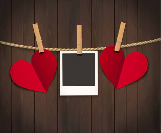 istock Red heart with photo frame on wood background with clothespin. Vector illustration. EPS 10 1212533798