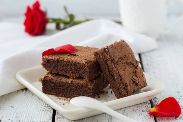 istock Plate with fresh brownies and ice-cream on table. Delicious chocolate pie 1212534047
