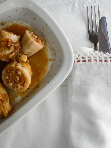 istock Delicious homemade stuffed squid with tomato and vegetable sauce 1212534211