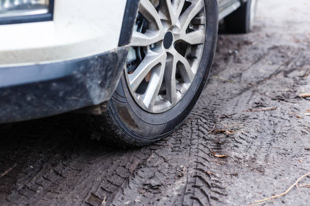istock wheels of a white car in the mud 1212534745