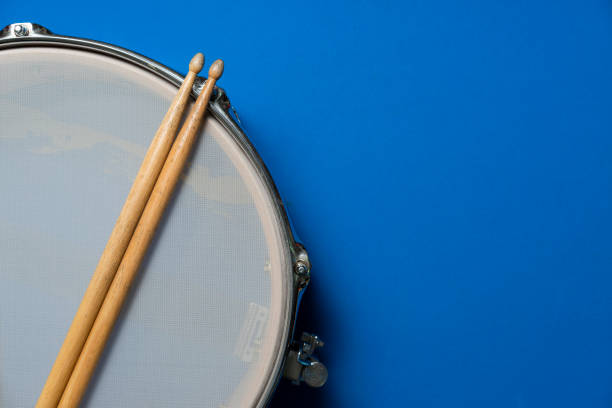 istock Drum stick and drum on blue table background, top view, music concept 1212536718