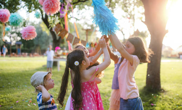 istock Small children with kite outdoors in garden in summer, playing. 1212537371