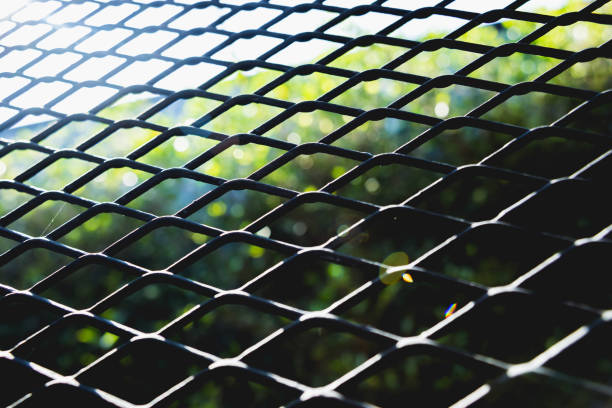 istock Abstract metal grid background. Lattice texture with big cells grid. 1212537777