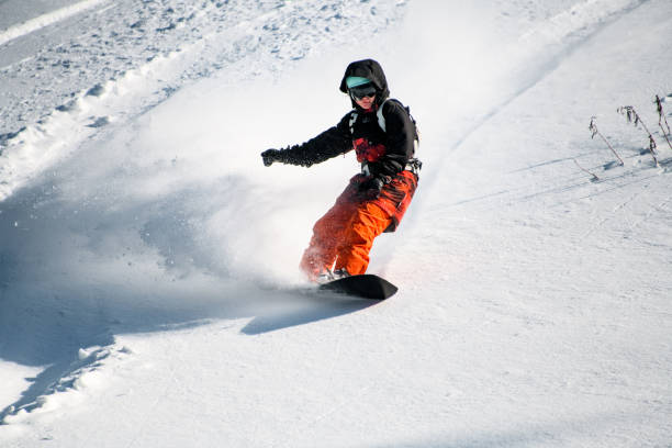 istock Girl sliding down from mountain on a professional snowboard 1212539270
