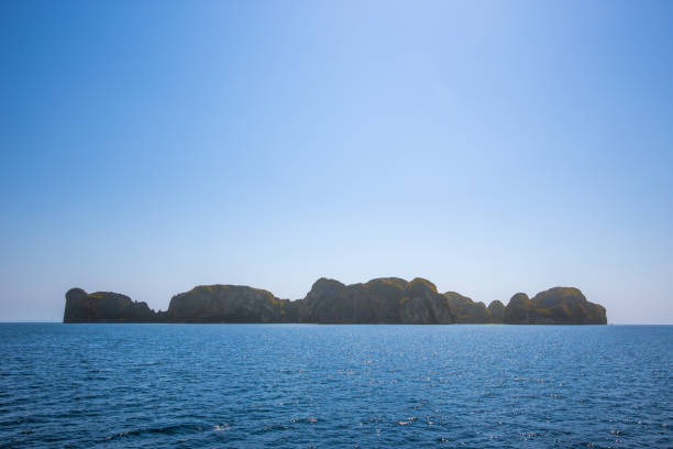 istock small island in a blue endless sea with copy space, summer travel vacation, Phi Phi island, Krabi, Thailand 1212539362