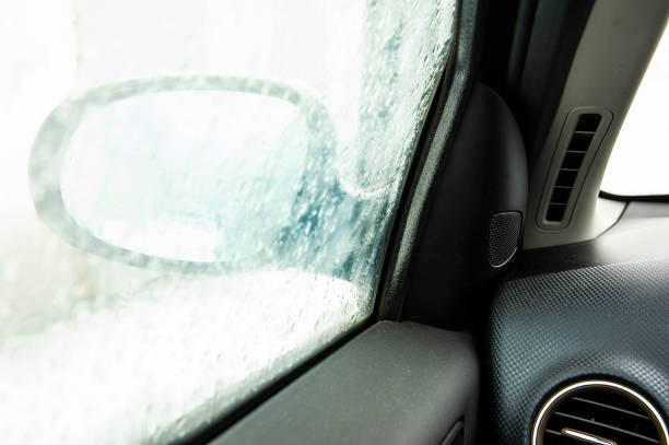 istock Steamy car window makes it difficult to look in the car mirror. Winter cold day. 1212539984