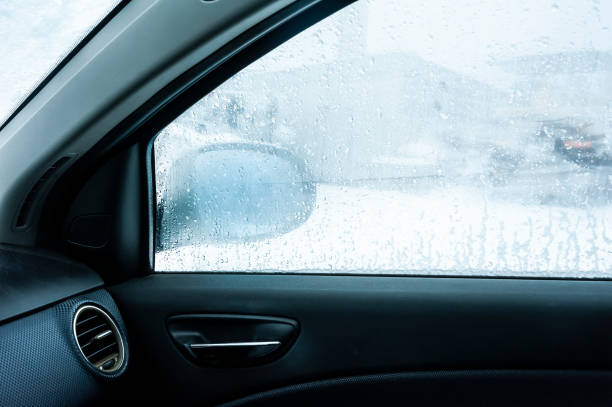 istock Steamy car window makes it difficult to look in the car mirror. Winter cold day. 1212540013