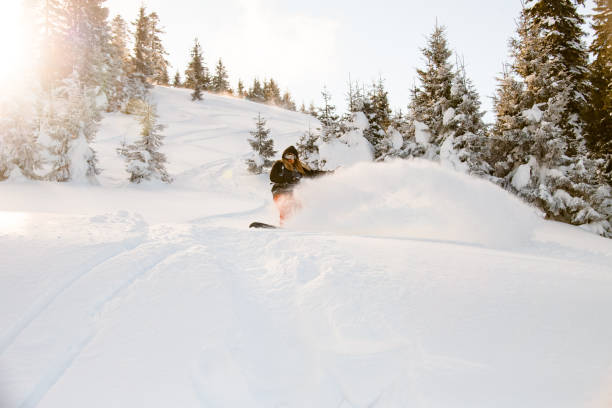 istock Man gliding from mountain on a professional snowboard 1212540185