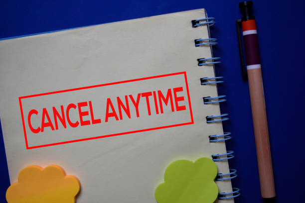 istock Cancel Anytime write on a book isolated on blue background. 1212540301