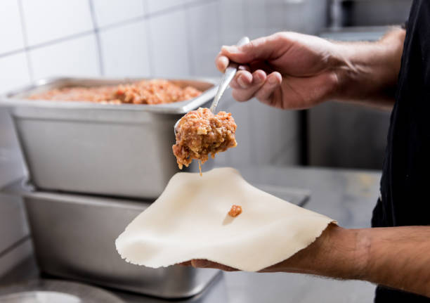 istock Chef coocking georgian khinkali or japanese wonton. 1212540850