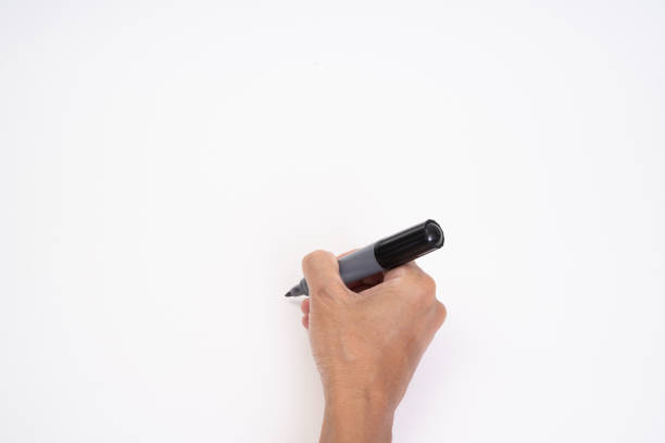 istock Man hand holding black magic marker pen writing on white background 1212542254