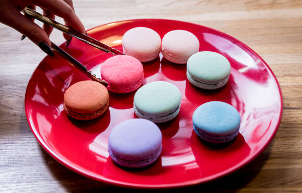 istock French colorful macarons on a red plate. Restaurant. 1212543140