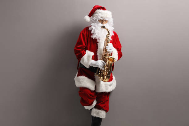 istock Santa Claus playing saxophone and leaning on a gray wall 1212544562