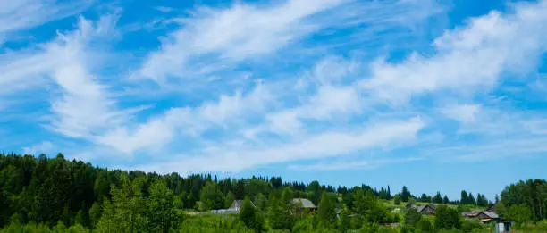 wooden houses on hillside with cloudy sky