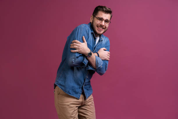 istock I'm afraid. Fright. Scared man. Business man standing isolated on trendy pink studio background. Human emotions, facial expression concept. 1212550015
