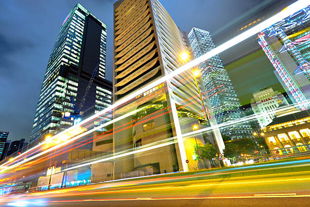 istock light trails on the modern building in Hong Kong 121255029