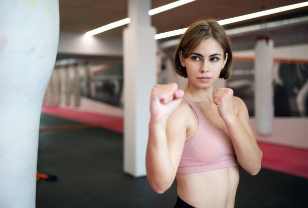 istock A young woman practising karate indoors in gym. 1212550384