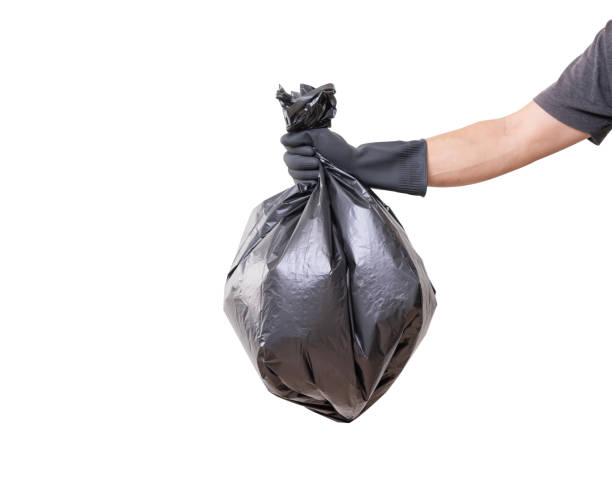 istock Hand holding trash bag isolated on white background, clipping path 1212550453