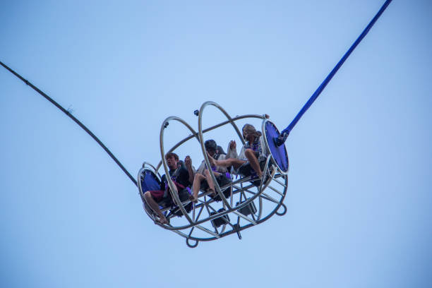 Copenhagen, Denmark - August 22, 2019: Amusement park carousel at the top with people enjoying the attraction in Copenhagen's Tivoli park