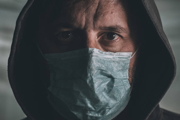 istock Afraid man with disposable respiratory mask 1212553506